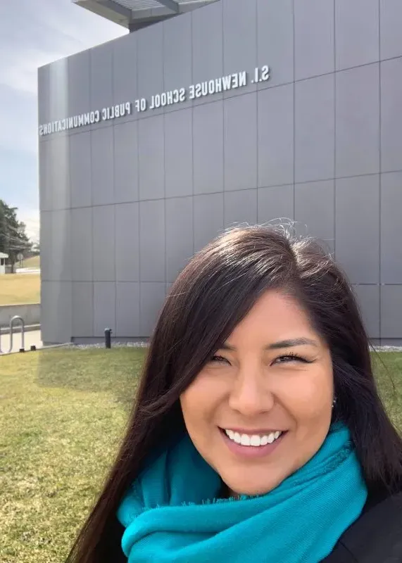 Jourdan Bennett-Begaye smiling outside of the Newhouse School.